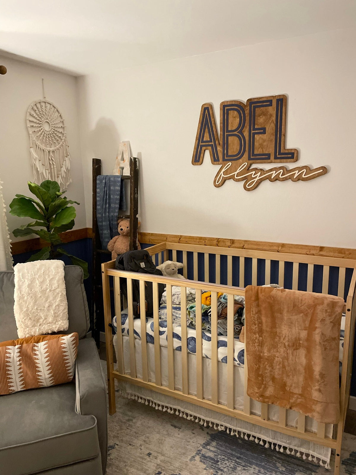 The Abel Flynn layered personalized wood name sign in a nursery