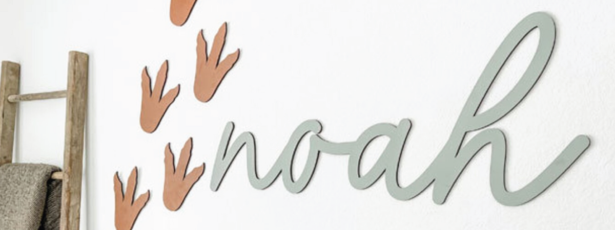 Noah cutout name sign with dinosaur footprints