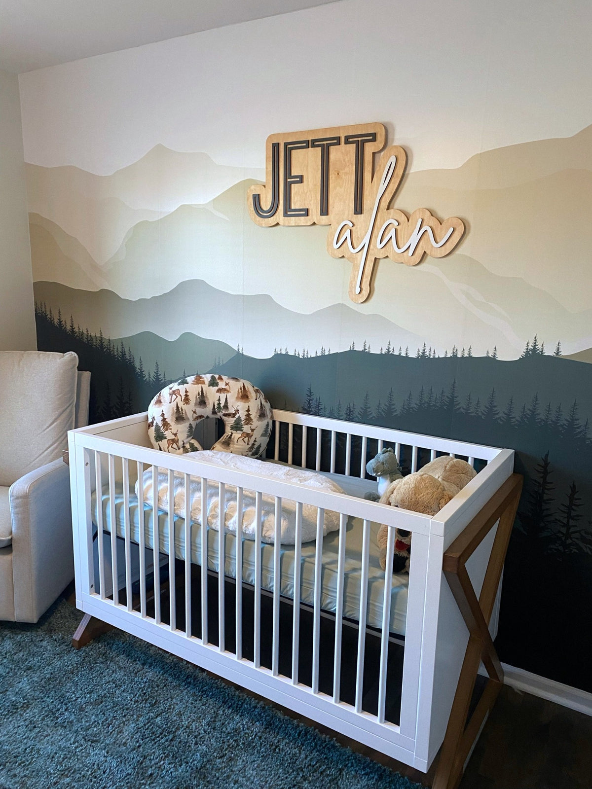 The Jett Alan layered personalized wood name sign in a nursery