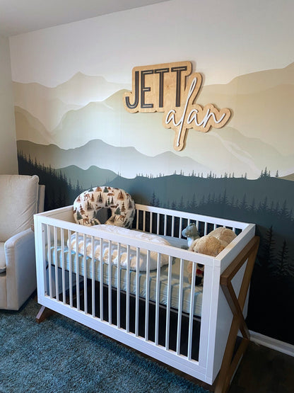 The Jett Alan layered personalized wood name sign in a nursery