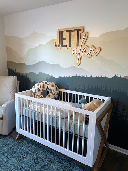 The Jett Alan layered personalized wood name sign in a nursery