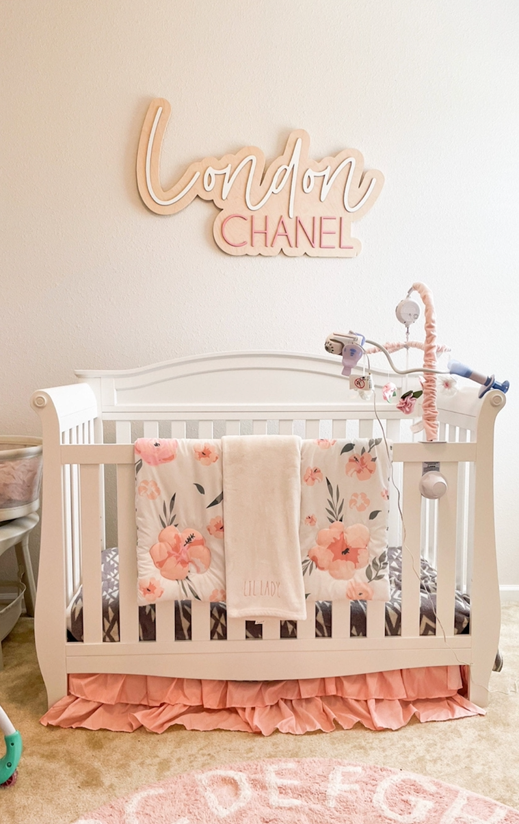 The London Chanel layered personalized wood name sign in a nursery
