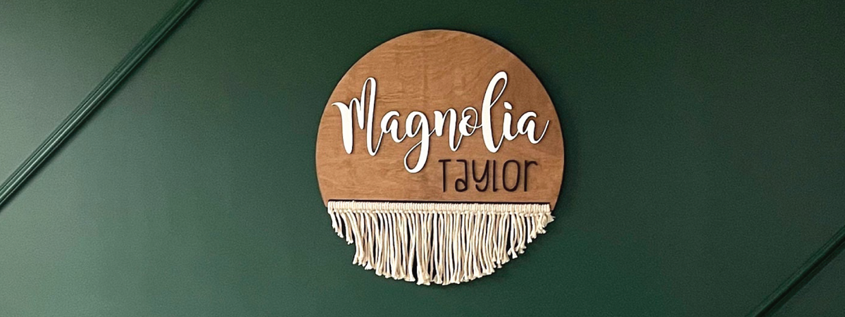 Magnolia Taylor personalized macrame name sign on a green wall