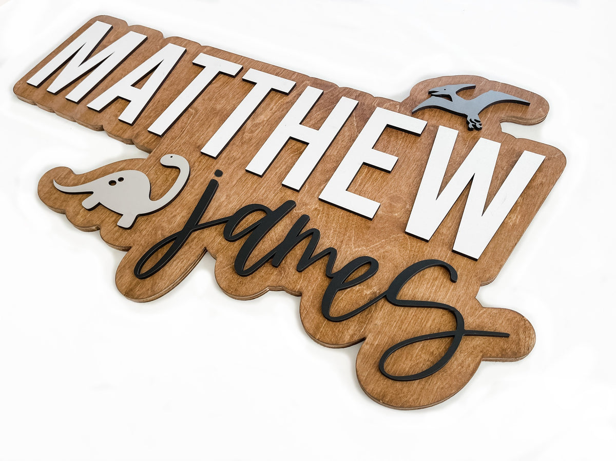 The Matthew James layered personalized wood name sign with dinosaur decals